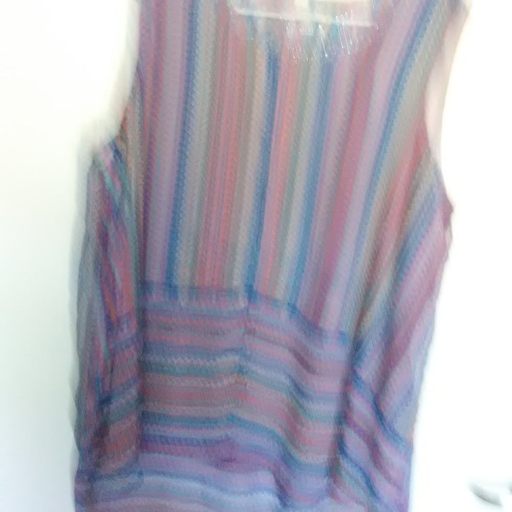 Sleeveless high low top with beads designed around the neck